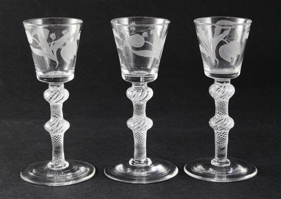 A set of three Jacobite type funnel-shaped wine glasses, c.1750, 5.7in. small foot chip to one